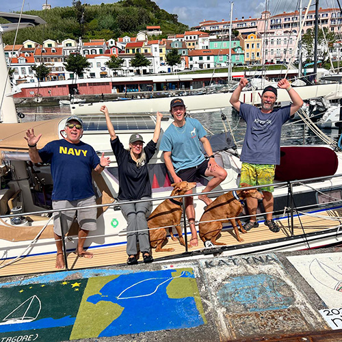 The crew of yacht Lema celebrate arriving in Horta, Azores