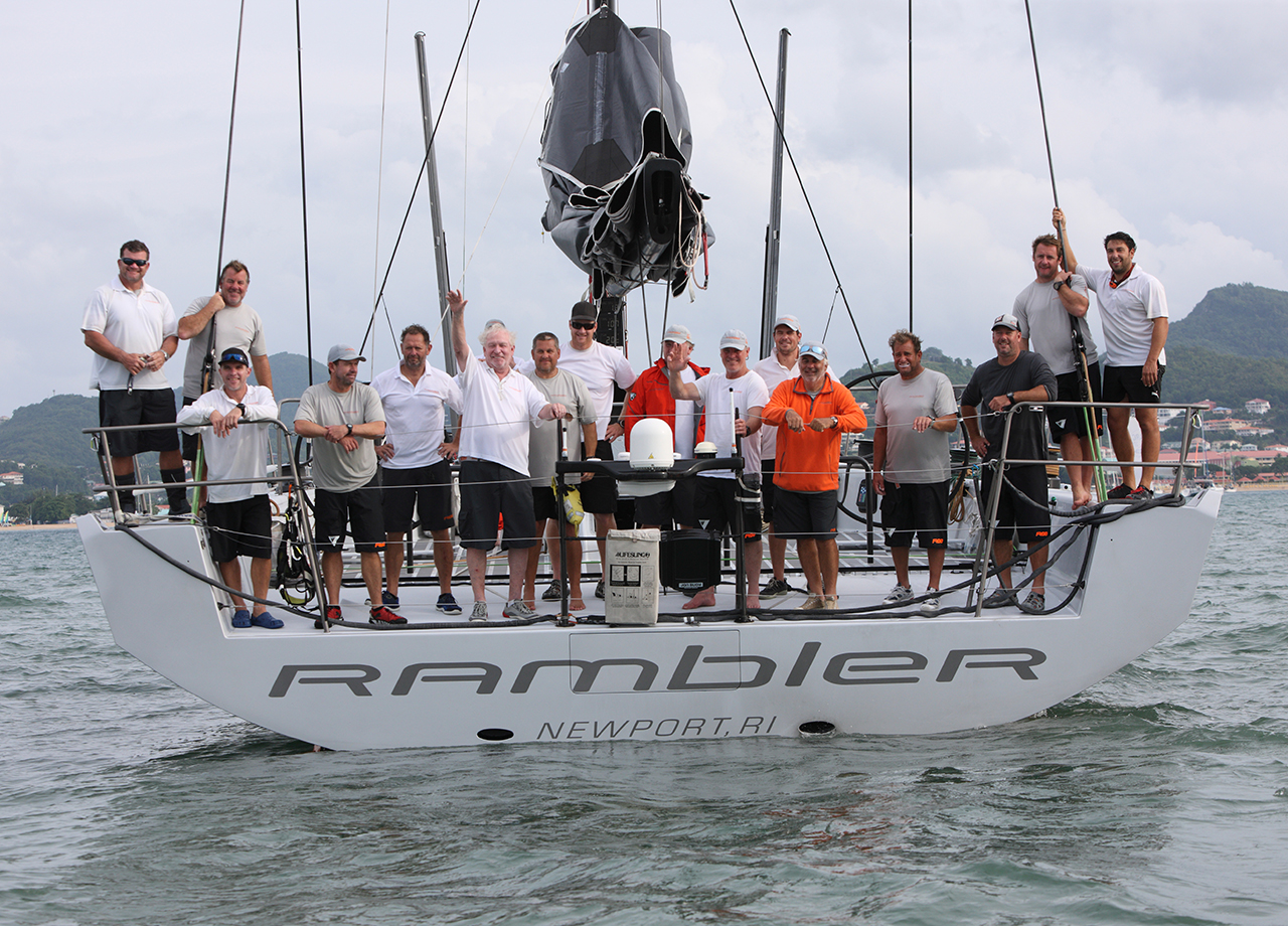 The professional crew of yacht Rambler 88 line up on the transom after finishing ARC 2016