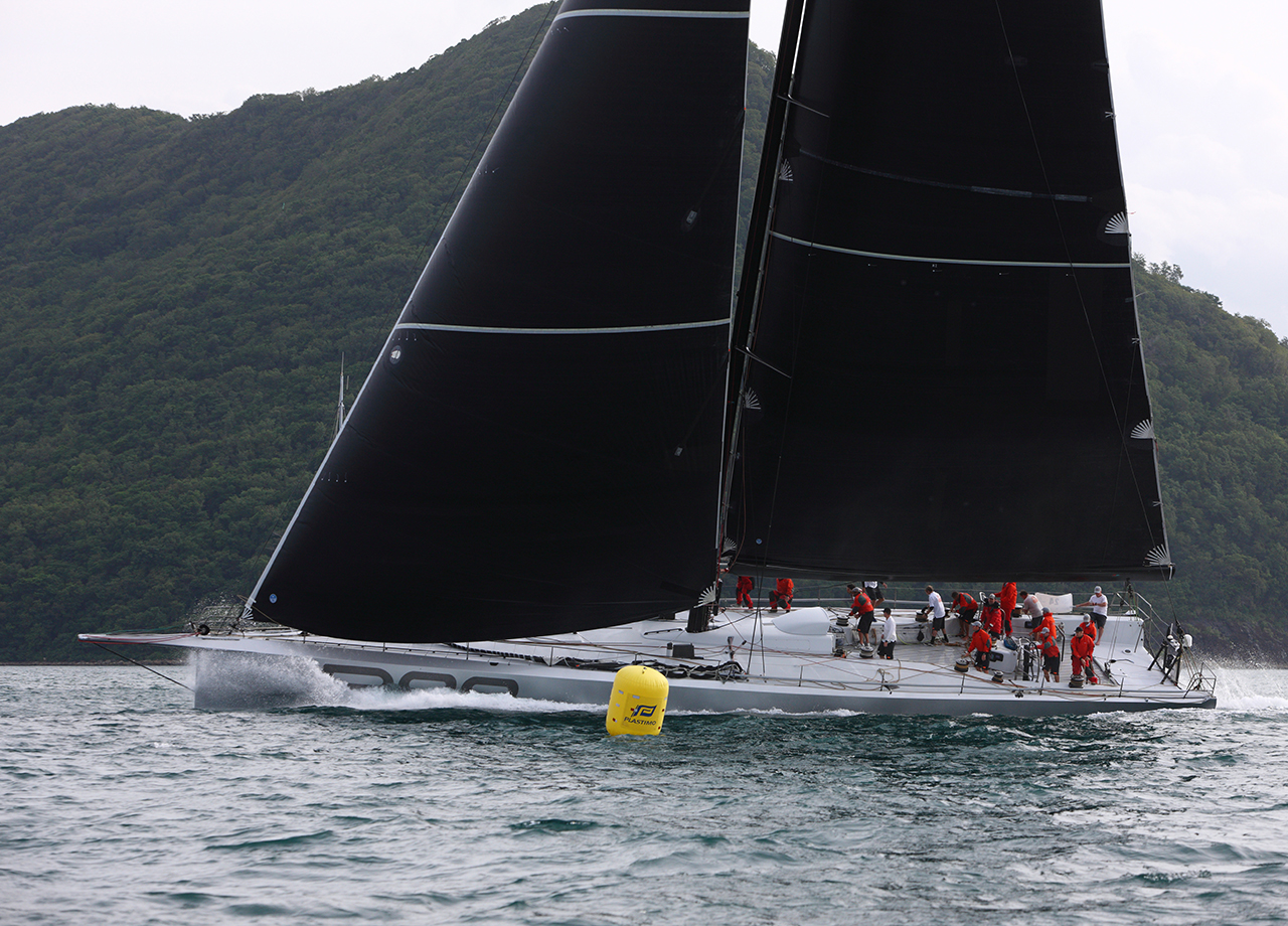 Silver maxi yacht Rambler 88 passes the yellow buoy at the finish of ARC 2016 in Saint Lucia