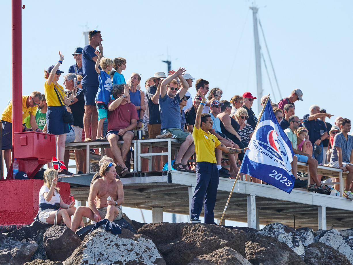 Waving crowds line the Las Palmas Marina wall at the start of ARC 2023