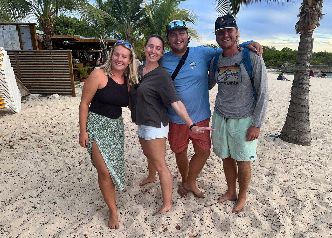 Two couples laugh at the beach barbecue hosted by SMX Tourism for ARC Europe 2025