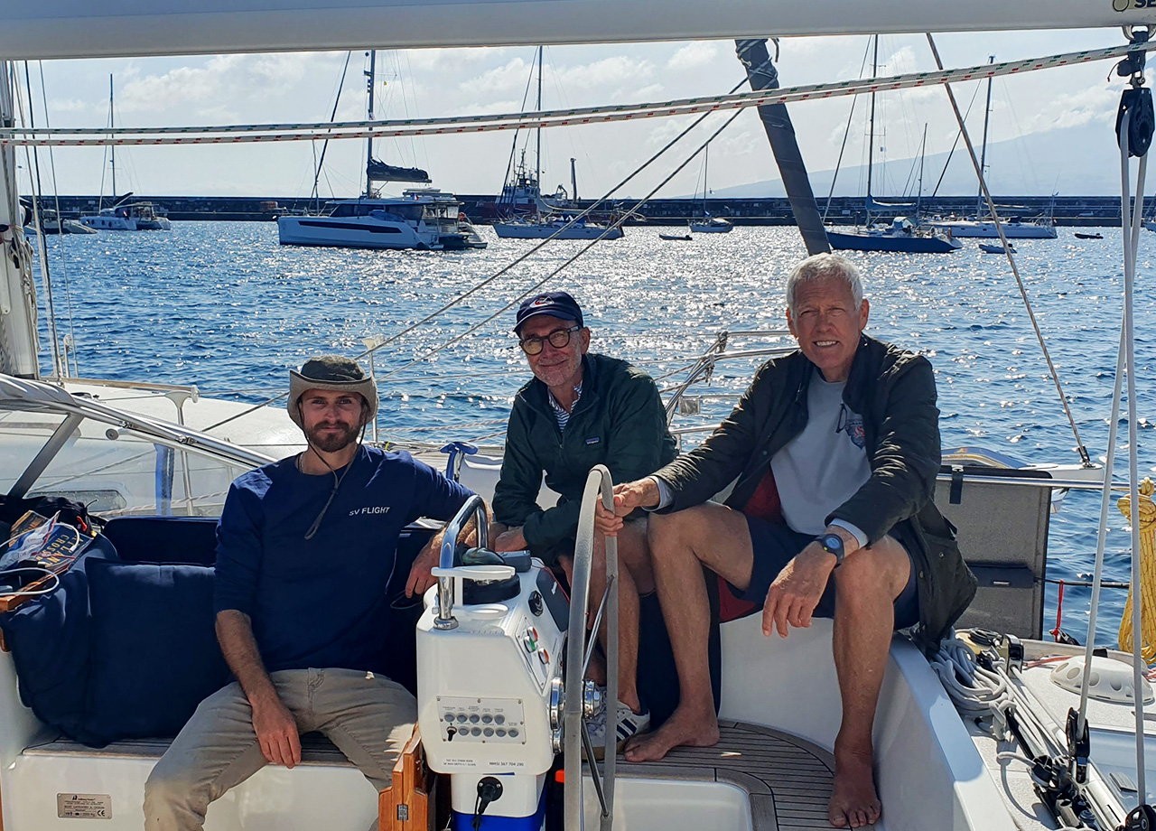 The crew of American yacht Flight relax in the cockpit in Horta on ARC Europe 2025
