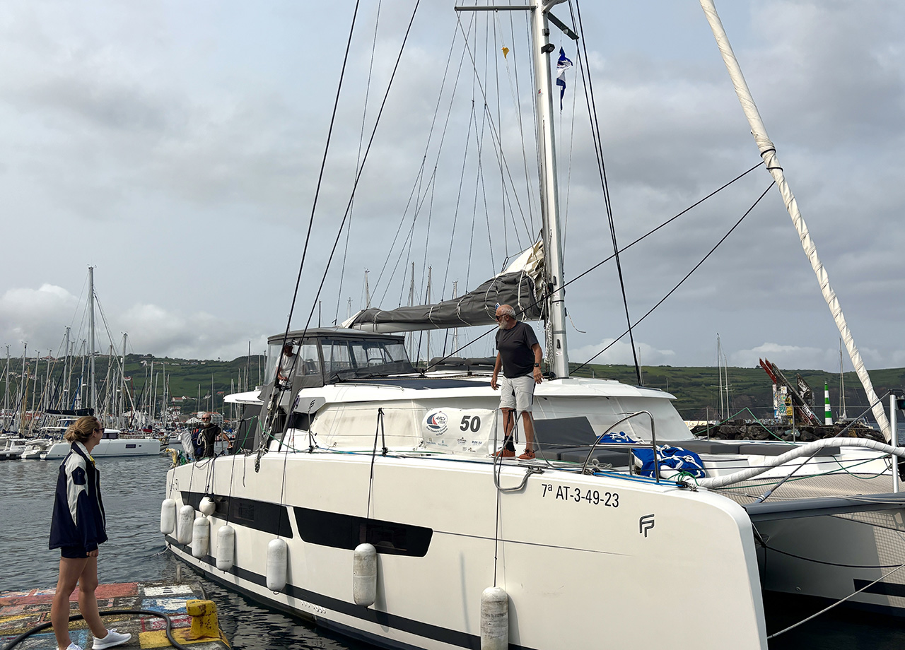 Catamaran Nargana comes alonside the harbour wall in Horta during ARC Europe 2025