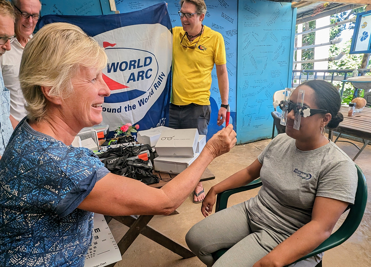 A woman opthamologist tests the eyesight of a Tongan national during a visit of World ARC