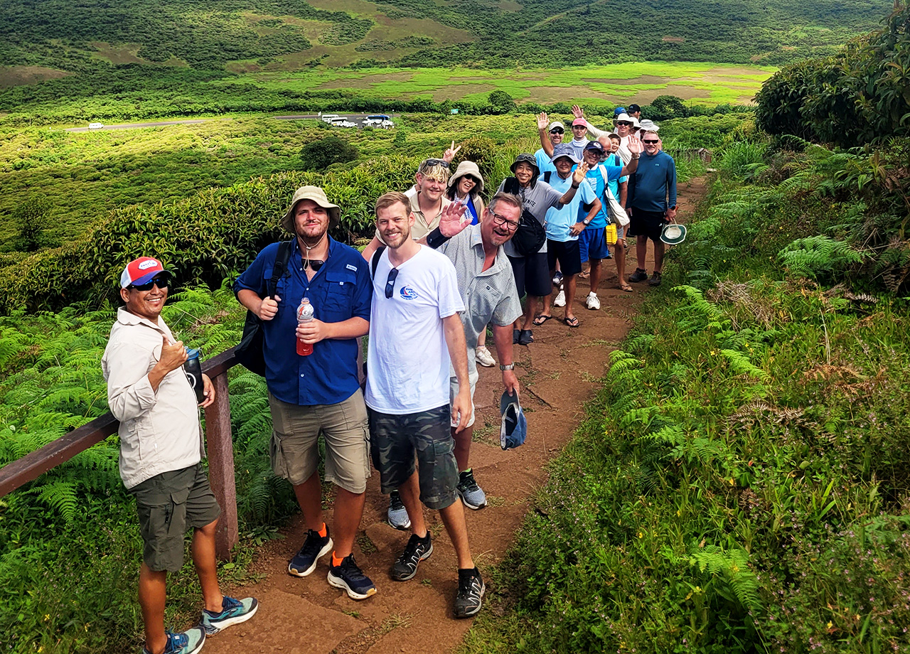World ARC sailors on an excursion ashore on San Cristobal, Galapagos walking up a narrow path into the mountains