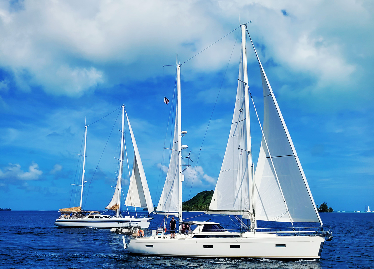Two ketch yachts sail in a gentle breeze in the Bora Bora lagoon in World ARC 2025-26