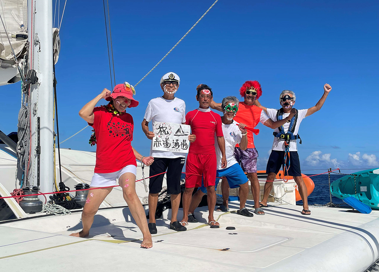 The crew of yacht Nakula celebrate crossing the equator on World ARC 2025-26