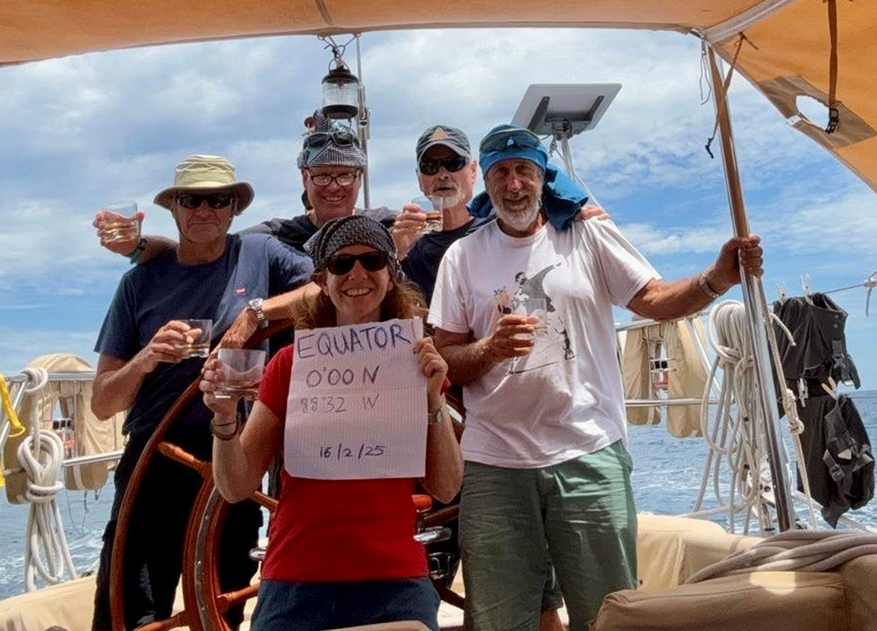 The crew of yacht Copihue celebrating crossing the equator on World ARC 2025-26 on the way to Galapagos