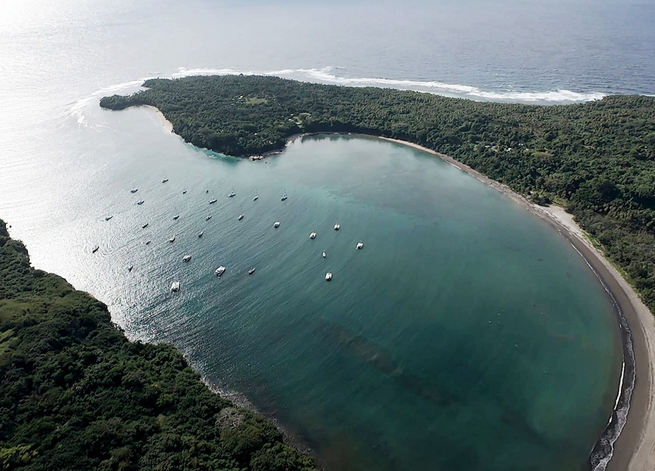 Almost circular Port Resoluton Bay in Tanna, Vanuatu with the World ARC 2025 yachts at anchor