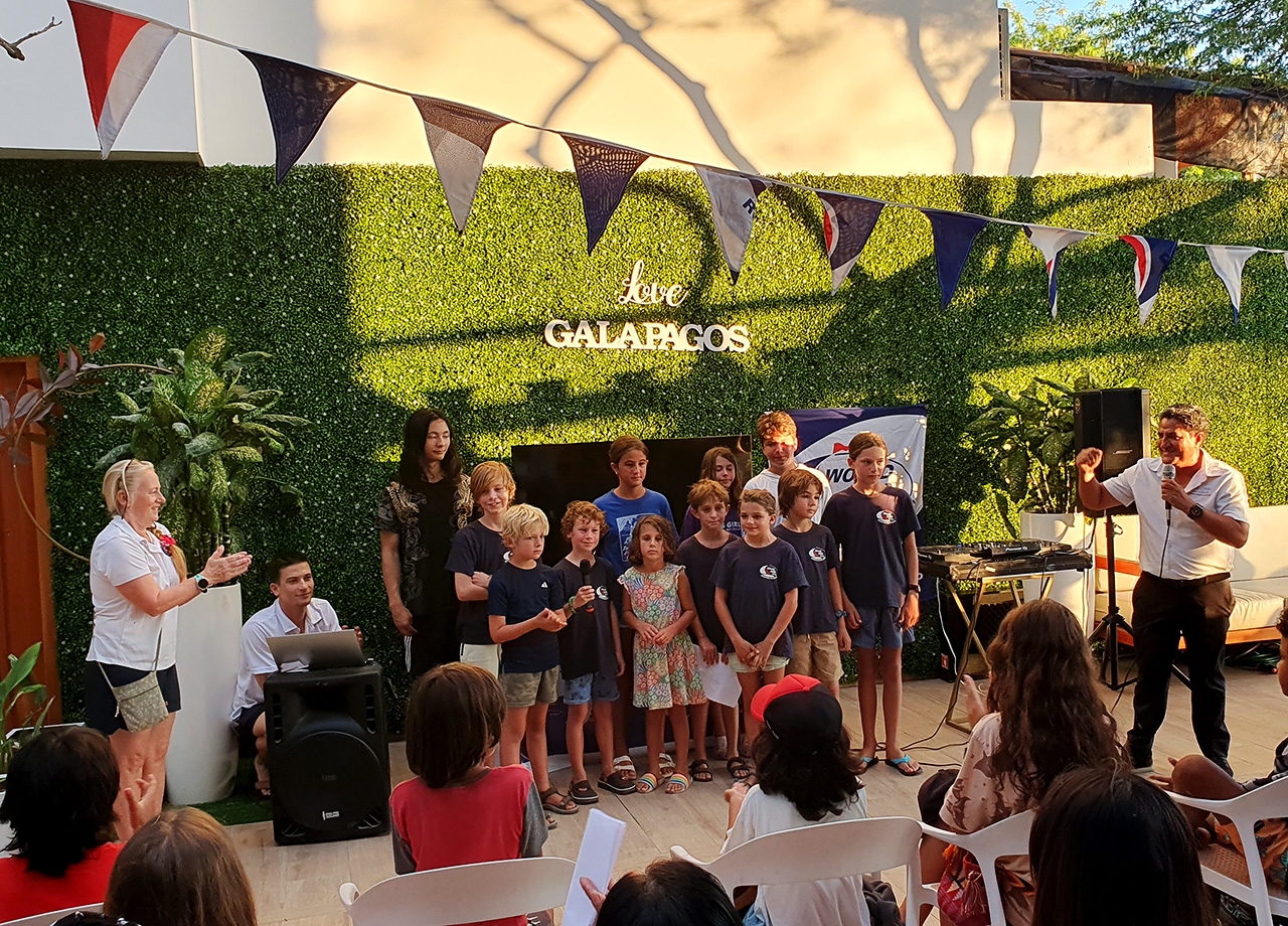Children from the World ARC fleet give a presentation about their lives onboard to local people in the cafe Umami