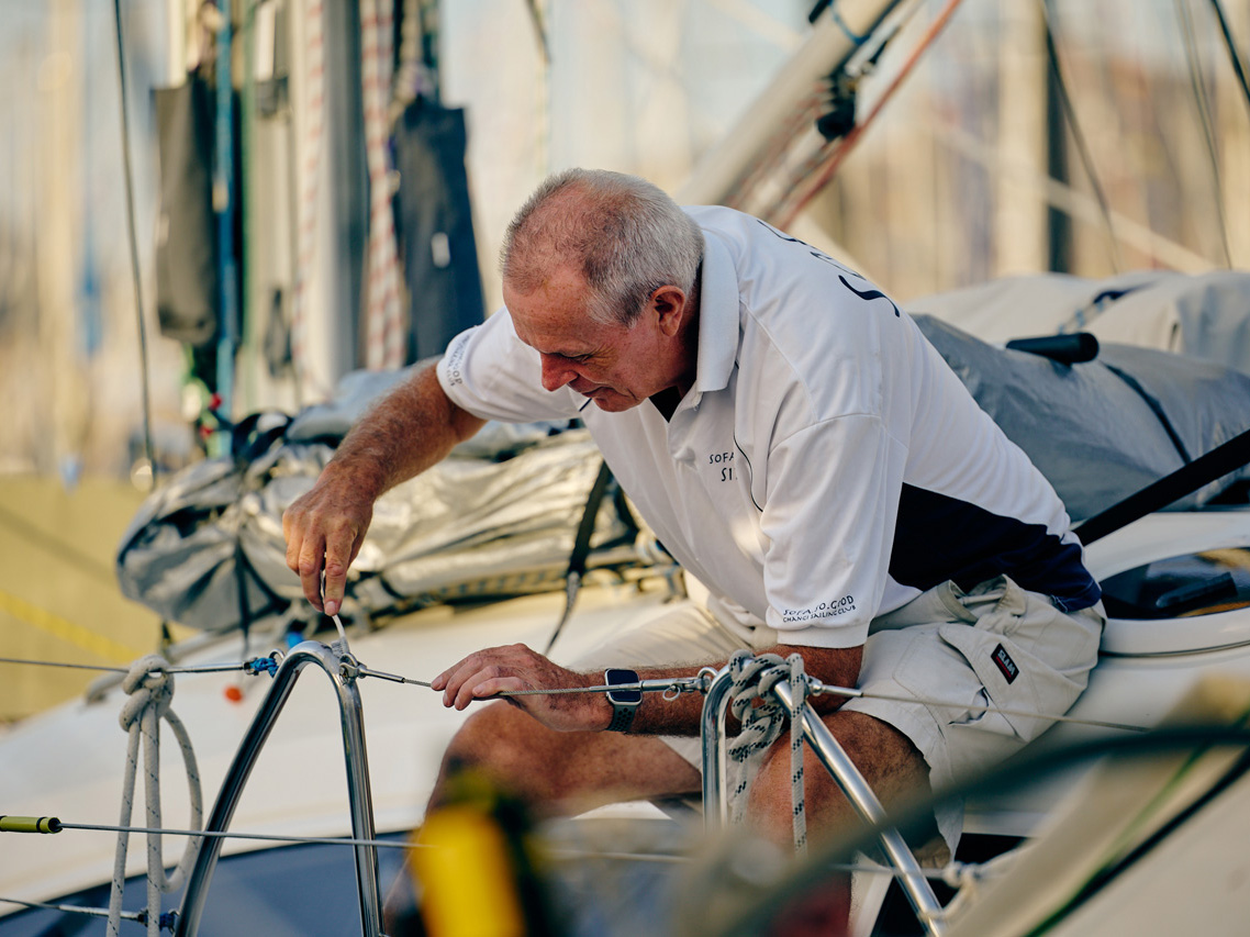 A man checks the safety lines of his boat before the start of ARC 2023