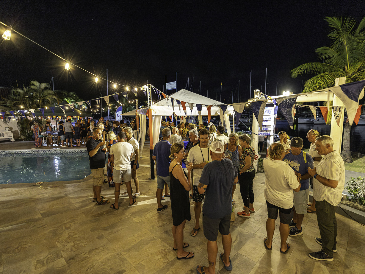 An evening party in Rodney Bay Marina around the swimming pool with flags and fairy lights